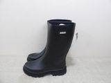 a pair of black rubber boots that are on the floor