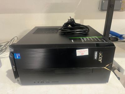 a close up of a black computer on a table with wires