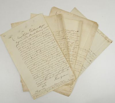 a bunch of old letters sitting on top of a white table