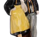 a figurine of a man and a woman standing on a pedestal