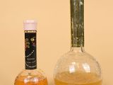 a bottle of liquid next to a bottle of liquor
