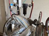 pipes and gauges in a room with a wall in the background