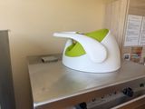 a white and green bowl sitting on top of a stove