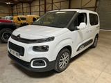 the white van is parked in a garage with other vehicles