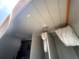 two white towels hanging on a clothes rack in a bathroom