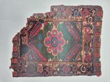 a very old rug with many different designs on it