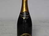 the bottle of champagne is sitting on a marble counter top