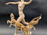 figurine of a woman with giraffes and a giraffe