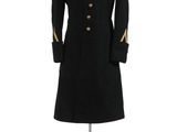 a black coat with gold buttons on a mannequin stand