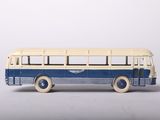 a toy bus that is sitting on a white surface