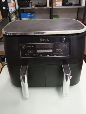 a black and silver coffee maker sitting on a table