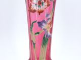 purple glass vase with flowers on it on a white background