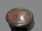 a small table with a metal base on a gray surface