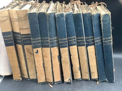 several old books are stacked on top of each other on a table