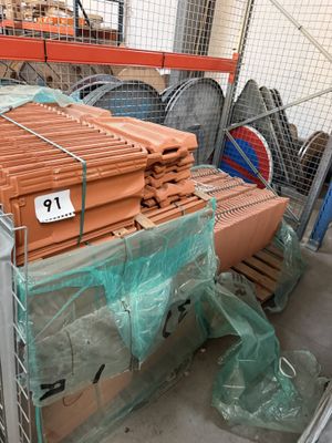 a large pile of bricks sitting on a pallet in a warehouse