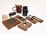 an image of a collection of old cameras and other items