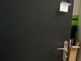 a black door with a sign on it in a room