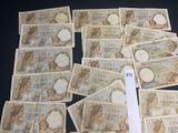 a lot of different bank notes on the table