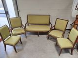 several chairs and a couch are arranged in a circle in a room