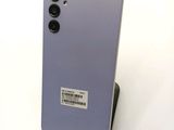 the back of a purple phone with a sticker on it