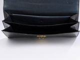 the black leather wallet is open on a white surface