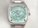 a silver watch with a green dial on it