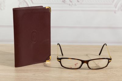 glasses and a book sitting on a table next to each other