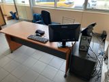 a desk with a computer monitor and keyboard on it