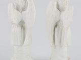 pair of white angel figurines on a white background