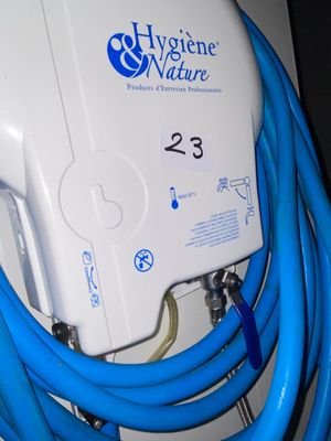a blue hose attached to a white wall mounted water heater