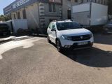 a white car parked in front of a building