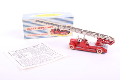 a close up of a toy fire truck with a box in the background