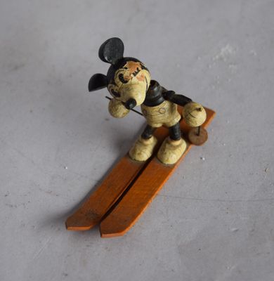 a small figurine of a dog on a snowboard