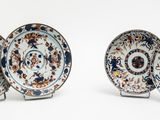 three plates with different designs on them on a white surface