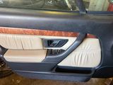 the interior of a car with the door open and the driver ' s seat up