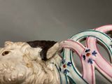 a figurine of a sheep with a ring around its neck
