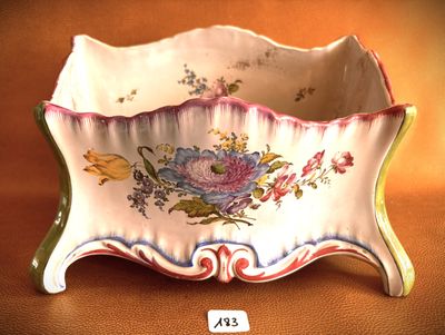 a small bowl with a floral design on it on a table
