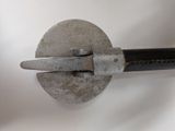 a metal object with a metal handle attached to it