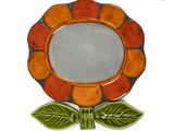 a small decorative mirror with a flower on it