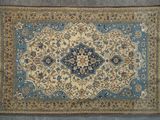 an antique persian rug with a blue border and a gold border