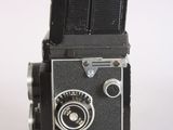 an old camera that is sitting on a white surface