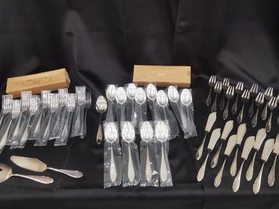a lot of forks and spoons on a table