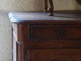 a wooden cabinet with a mirror on top of it