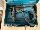 a blue box with a hammer and a cord in it