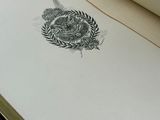 an open book with a drawing of a dragon on it