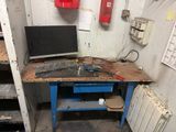a desk with a monitor and a keyboard on it