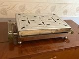 a small metal box on top of a wooden table