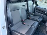 two seats in the back of a van with a cup holder