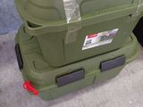 two green boxes stacked on top of each other on the floor