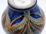 a blue vase with a brown and green design on it